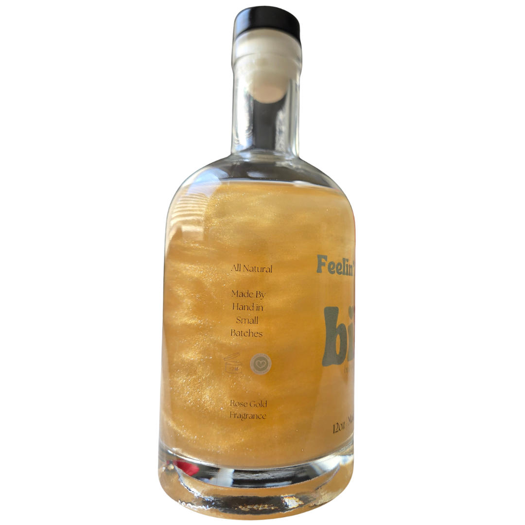 Bottle of 'bibi' brand rose gold liquid on a white background